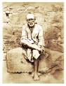 Shirdi Sai Baba seated on stone